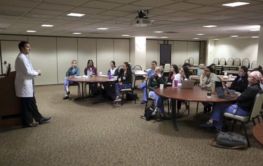 Dr. Keith Reisinger-Kindle, associate director of the OB-GYN residency program at Wright State University's medical school in Dayton, Ohio, leads a lecture of OB-GYN residents in the Wright State program Wednesday, April 13, 2022. The physician created and implemented abortion coursework for medical students and residents, with support from his university, and offers training at a nearby clinic where he also performs abortions. (AP Photo/Paul Vernon) **FILE**