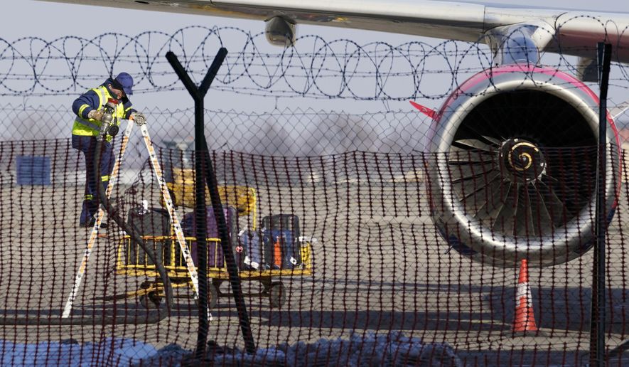 A worker fixes an Air Serbia passenger plane at Belgrade&#39;s Nikola Tesla Airport, Serbia, Monday, Jan. 17, 2022. Ukraine on Monday, April 18, 2022 rejected as baseless and false accusations made by Serbia&#39;s president that Ukraine&#39;s secret service is behind a series of hoax bomb threats against Air Serbia flights to Russia. Serbian President Aleksandar Vucic has said foreign intelligence services of Ukraine and an unidentified European Union state &amp;quot;are doing that.&amp;quot; (AP Photo/Darko Vojinovic, File)
