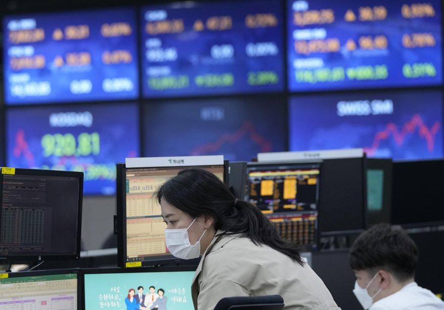 A currency trader watches monitors at the foreign exchange room of the KEB Hana Bank headquarters in Seoul, South Korea, Monday, April 18, 2022. Shares were lower in Asia after China reported Monday that its economy expanded at a 4.8% annual pace in January-March. (AP Photo/Ahn Young-joon)
