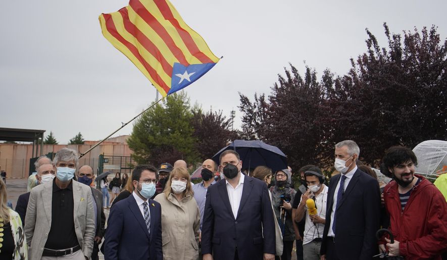 FILE - Former deputy president of the Catalan regional government Oriol Junqueras, centre, walks with the current Catalonian president Pere Aragones, 2nd left, in front of an &amp;quot;estelada&amp;quot; or Catalan pro-independence flag after being released from the Lledoners prison in Sant Joan de Vilatorrada near Barcelona, Spain, June 23, 2021. The phones of dozens of pro-independence supporters in Spain&#39;s northeastern Catalonia, including the regional chief and other elected officials, were hacked with controversial spyware available only to governments, a cybersecurity rights nonprofit said Monday April 18, 2022. (AP Photo/Joan Mateu, File)