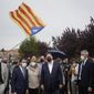 FILE - Former deputy president of the Catalan regional government Oriol Junqueras, centre, walks with the current Catalonian president Pere Aragones, 2nd left, in front of an &amp;quot;estelada&amp;quot; or Catalan pro-independence flag after being released from the Lledoners prison in Sant Joan de Vilatorrada near Barcelona, Spain, June 23, 2021. The phones of dozens of pro-independence supporters in Spain&#39;s northeastern Catalonia, including the regional chief and other elected officials, were hacked with controversial spyware available only to governments, a cybersecurity rights nonprofit said Monday April 18, 2022. (AP Photo/Joan Mateu, File)