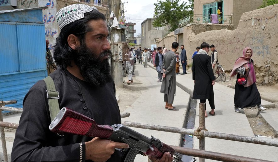 A Taliban fighter stands guard at the site of an explosion in front of a school, in Kabul, Afghanistan, Tuesday, April 19, 2022. An Afghan police spokesman says explosions targeting educational institutions in Kabul have killed at least six civilians and injured over 10 others. Khalid Zadran said Tuesday the blasts occurred in the mostly-Shiite Muslim area in the west of Afghanistan&#x27;s capital. (AP Photo/Ebrahim Noroozi)
