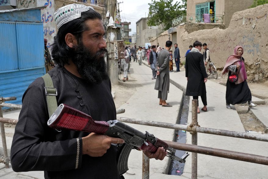 A Taliban fighter stands guard at the site of an explosion in front of a school, in Kabul, Afghanistan, Tuesday, April 19, 2022. An Afghan police spokesman says explosions targeting educational institutions in Kabul have killed at least six civilians and injured over 10 others. Khalid Zadran said Tuesday the blasts occurred in the mostly-Shiite Muslim area in the west of Afghanistan&#39;s capital. (AP Photo/Ebrahim Noroozi)