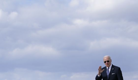 President Joe Biden waves to members of the press as he walks to a motorcade vehicle after stepping off Air Force One, Tuesday, April 19, 2022, at Andrews Air Force Base, Md. Biden is returning to Washington after promoting his infrastructure agenda in New Hampshire. (AP Photo/Patrick Semansky)