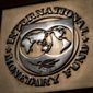 The logo of the International Monetary Fund is visible on their building, April 5, 2021, in Washington. The International Monetary Fund downgraded the outlook for the world economy this year and next, blaming the Ukraine war for disrupting global commerce, pushing up oil prices, threatening food supplies and increasing uncertainty already heightened by COVID-19 and its variants. (AP Photo/Andrew Harnik)