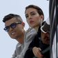 FILE - Cristiano Ronaldo, left, is flanked by his partner Georgina Rodriguez as they watch the second practice session at the Monaco racetrack, in Monaco, Thursday, May 23, 2019. (AP Photo/Luca Bruno, File)