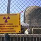 A sign warning of radioactive materials is seen on a fence around a nuclear reactor containment building on Monday, April 26, 2021, a few days before it stopped generating electricity at Indian Point Energy Center in Buchanan, N.Y. The Biden administration is launching a $6 billion effort to save nuclear power plants at risk of closing, citing the need to continue nuclear energy as a carbon-free source of power that helps to combat climate change. (AP Photo/Seth Wenig, File)