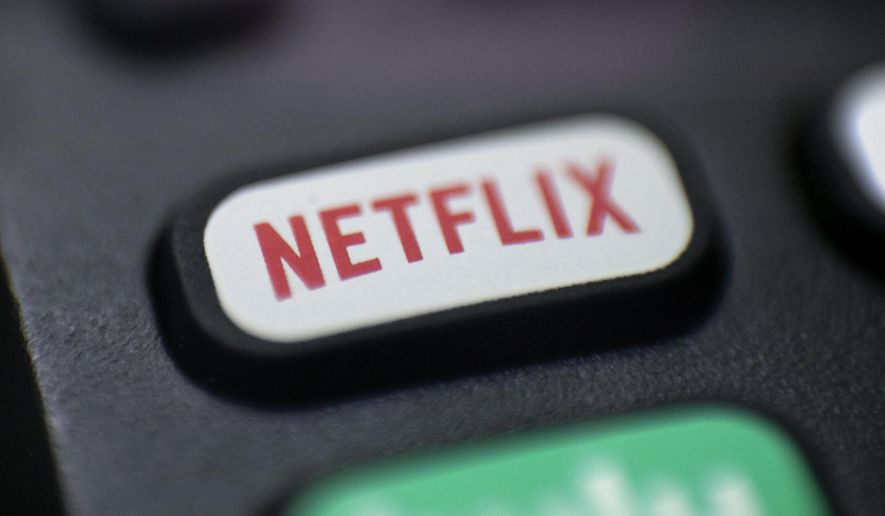 FILE - This Aug. 13, 2020, photo shows a logo for Netflix on a remote control in Portland, Ore. Netflix’s video streaming service suffered the first loss in worldwide subscribers in its history, leading to a massive sell-off of its shares. The company’s customer base fell by 200,000 subscribers during the January-March period, according to a quarterly report released Tuesday, April 19, 2022; its stock dropped by 23% in after-market trading. (AP Photo/Jenny Kane, file)