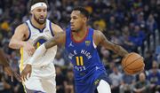 Denver Nuggets guard Monte Morris, right, drives to the basket against Golden State Warriors guard Klay Thompson during the first half of Game 2 of an NBA basketball first-round playoff series in San Francisco, Monday, April 18, 2022. (AP Photo/Jeff Chiu)