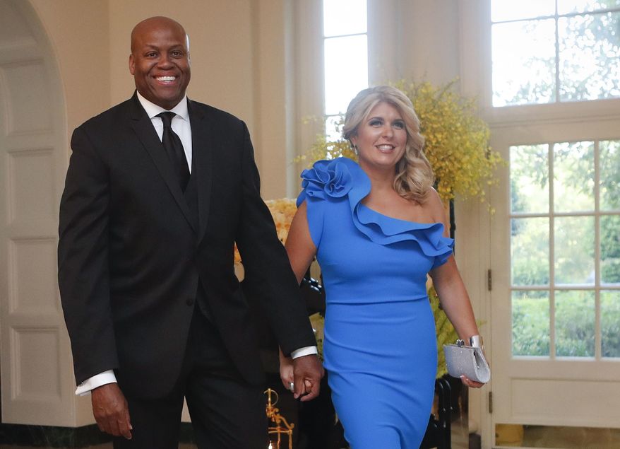 Craig Robinson, brother of former first lady Michelle Obama, and his wife, Kelly Robinson, arrive for a State Dinner for Singapore's Prime Minister Lee Hsien Loong, Tuesday, Aug. 2, 2016, at the White House in Washington. The Robinsons are suing a private Milwaukee school alleging it refused to allow their two young sons to re-enroll after they raised concerns about racial and ethnic bias by school staff. (AP Photo/Pablo Martinez Monsivais, File)