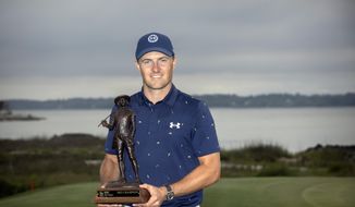 Jordan Spieth holds the championship trophy after winning a one-hole playoff at the RBC Heritage golf tournament, Sunday, April 17, 2022, in Hilton Head Island, S.C. (AP Photo/Stephen B. Morton) **FILE**