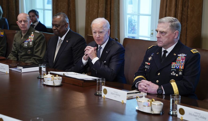 President Joe Biden listens during a meeting with Gen. David Berger, Commandant of the Marine Corps, left, Secretary of Defense Lloyd Austin, and Chairman of the Joint Chiefs of Staff Gen. Mark Milley, and other military leaders in the Cabinet Room the White House, Wednesday, April 20, 2022, in Washington. (AP Photo/Evan Vucci)