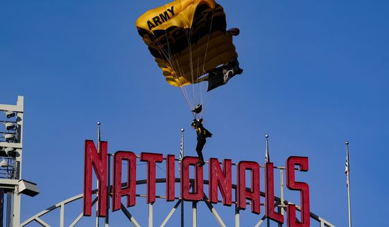 The U.S. Army Parachute Team the Golden Knights descend into National Park before a baseball game between the Washington Nationals and the Arizona Diamondbacks Wednesday, April 20, 2022, in Washington. The U.S. Capitol was briefly evacuated after police said they were tracking an aircraft that poses a probable threat, but the plane turned out to be the military aircraft with people parachuting out of it for a demonstration at the Nationals game, officials told The Associated Press. (AP Photo/Alex Brandon)