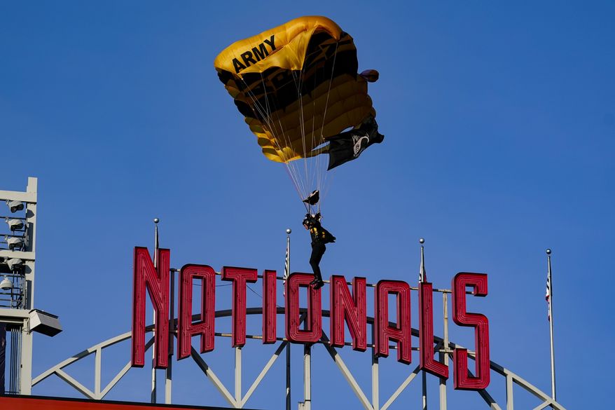 The U.S. Army Parachute Team the Golden Knights descend into National Park before a baseball game between the Washington Nationals and the Arizona Diamondbacks Wednesday, April 20, 2022, in Washington. The U.S. Capitol was briefly evacuated after police said they were tracking an aircraft that poses a probable threat, but the plane turned out to be the military aircraft with people parachuting out of it for a demonstration at the Nationals game, officials told The Associated Press. (AP Photo/Alex Brandon)