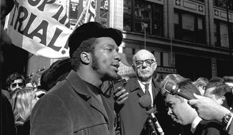 FILE - In this Oct. 29, 1969, photo, Fred Hampton, center, chairman of the Illinois Black Panther party, speaks outside a rally outside the U.S. Courthouse in Chicago while Dr. Benjamin Spock, background, listens. The Illinois childhood home of Hampton, an iconic Black Panther Party leader who was shot and killed during a 1969 police raid of his Chicago apartment, has been designated a historical landmark. (AP Photo/ESK, File)