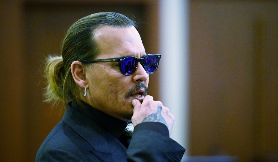 Actor Johnny Depp listens during a hearing at the Fairfax County Circuit Court in Fairfax, Va., Tuesday April 19, 2022. Depp sued his ex-wife Heard for libel in Fairfax County Circuit Court after she wrote an op-ed piece in The Washington Post in 2018 referring to herself as a &amp;quot;public figure representing domestic abuse.&amp;quot; (Jim Watson/Pool Photo via AP)