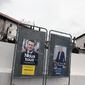 Presidential campaign posters of French President and centrist candidate for reelection Emmanuel Macron and French far-right presidential candidate Marine Le Pen in Arbonne, southwestern France, Tuesday, April 19, 2022. French President Emmanuel Macron is facing off against far-right challenger Marine Le Pen in France&#39;s April 24 presidential runoff. (AP Photo/Bob Edme)
