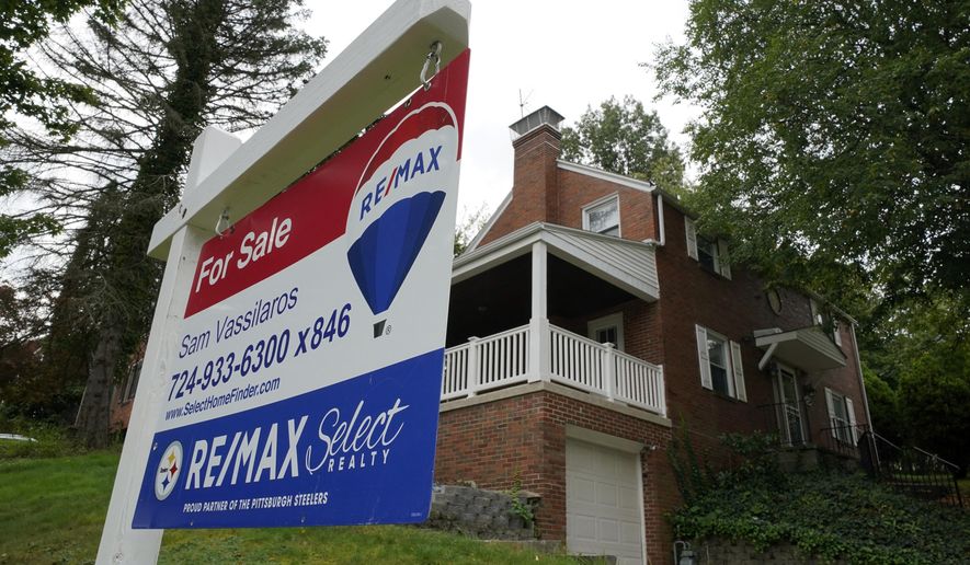FILE - A for sale sign is displayed outside a home in Mount Lebanon, Pa., on Tuesday, Sept. 21, 2021.   Sales of previously occupied U.S. homes slowed in March 2022, to the slowest pace in nearly two years as a swift rise in mortgage rates and record-high prices discouraged would-be homebuyers. The National Association of Realtors said Wednesday, April 20, 2022, that existing home sales fell 2.7% last month from February to a seasonally adjusted annual rate of 5.77 million.  (AP Photo/Gene J. Puskar, File)