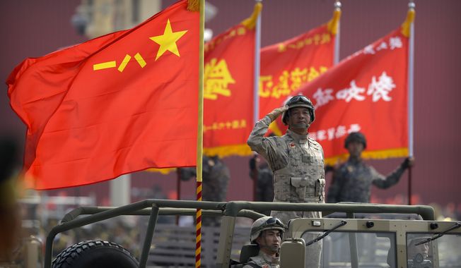 A military officer salutes during a parade to commemorate the 70th anniversary of the founding of Communist China in Beijing, Tuesday, Oct. 1, 2019. With Russia’s military failings in Ukraine mounting, no country is paying closer attention than China to how a smaller, outgunned force has badly bloodied what was thought to be one of the world’s strongest armies. (AP Photo/Mark Schiefelbein, File)