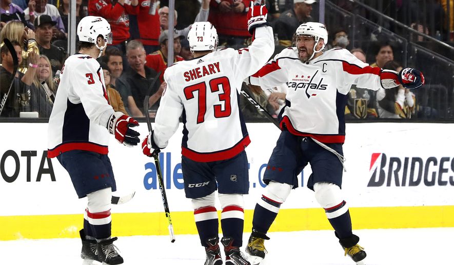 Washington Capitals left wing Alex Ovechkin, right, celebrates his goal with Nick Jensen (3) and Conor Sheary (73) during the third period of an NHL hockey game against the Vegas Golden Knights on Wednesday, April 20, 2022, in Las Vegas. (Steve Marcus/Las Vegas Sun via AP)