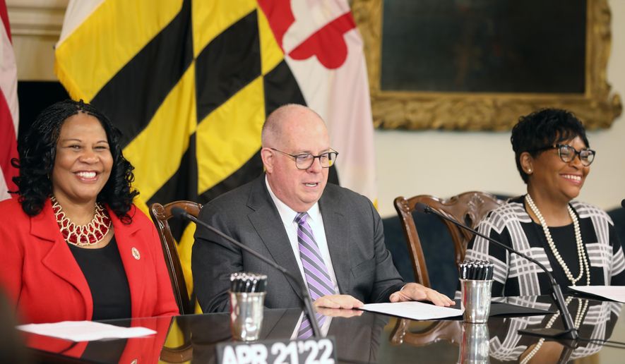 Maryland Senate President Pro Tem Melony Griffith, left, and House Speaker Adrienne Jones, right, smile at a bill-signing ceremony with Gov. Larry Hogan on Thursday, April 21, 2022 in Annapolis, Md. (AP Photo/Brian Witte)