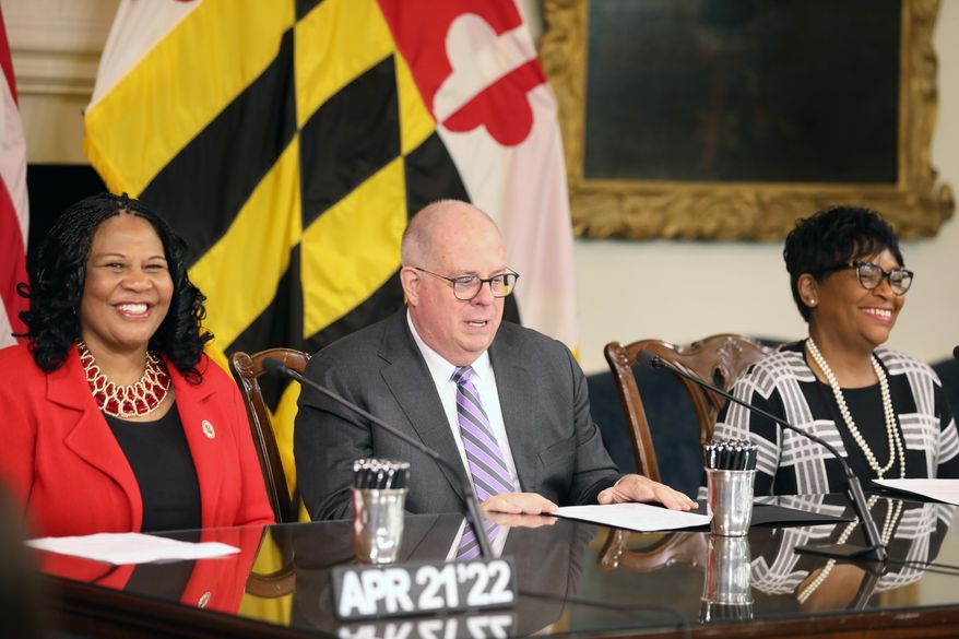Maryland Senate President Pro Tem Melony Griffith, left, and House Speaker Adrienne Jones, right, smile at a bill-signing ceremony with Gov. Larry Hogan on Thursday, April 21, 2022 in Annapolis, Md. (AP Photo/Brian Witte)