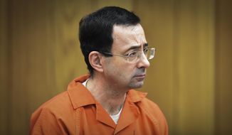 In this Feb. 5, 2018 file photo, Larry Nassar, former sports doctor who admitted molesting some of the nation&#39;s top gymnasts, appears in Eaton County Court in Charlotte, Mich. Thirteen sexual assault victims of Nassar are seeking $10 million each from the FBI, claiming a bungled investigation by agents led to more abuse by the sports doctor, lawyers said Thursday, April 21, 2022. (Matthew Dae Smith/Lansing State Journal via AP, File) **FILE**