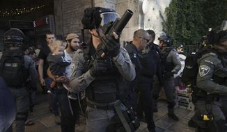 Israeli security forces escort a group of Jews outside Damascus Gate, in Jerusalem&#39;s Old City, Wednesday, April 20, 2022. Police prevented hundreds of ultra-nationalist Israelis from marching around predominantly Palestinian areas of Jerusalem&#39;s Old City. The event planned for Wednesday was similar to one that served as one of the triggers of last year&#39;s Israel-Gaza war. (AP Photo/Mahmoud Illean)