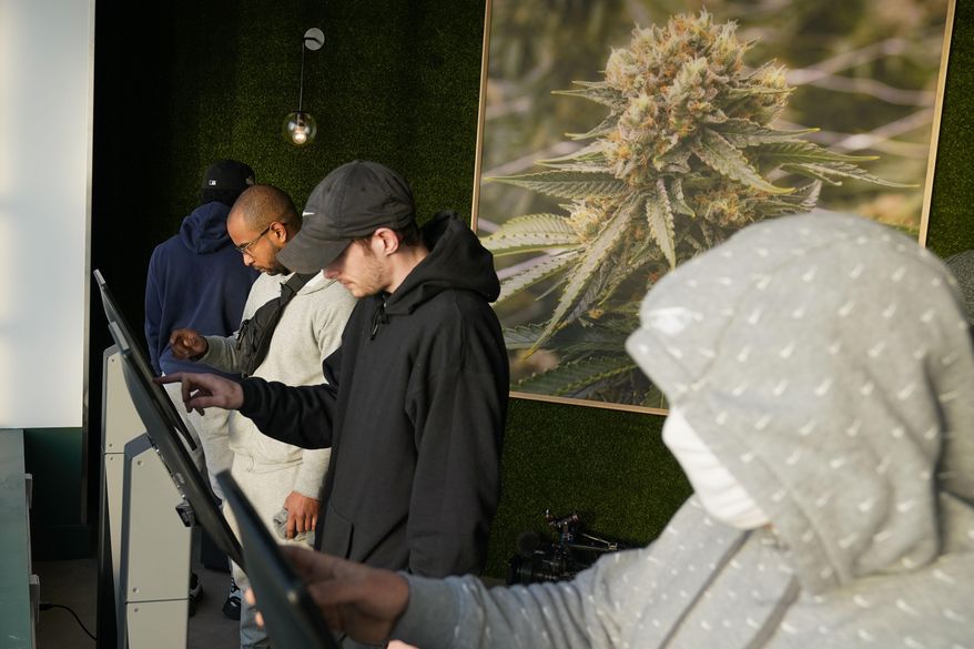 Customers place orders for cannabis products on tablets at a RISE dispensary in Bloomfield, N.J., Thursday, April 21, 2022. Recreational sales of cannabis for adults 21 and older started Thursday, with the first alternative treatment centers opening at 6 a.m. in part of the state. (AP Photo/Seth Wenig)