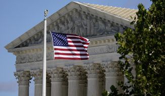 An American flag blows in the wind in front of the Supreme Court building on Capitol Hill in Washington, Nov. 2, 2020. (AP Photo/Patrick Semansky, File)