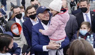 FILE - President Joe Biden meets with Ukrainian refugees during a visit to PGE Narodowy Stadium, March 26, 2022, in Warsaw. The Biden administration is making it easier for refugees fleeing Russia’s war on Ukraine to come to the United States from Europe while trying to shut down an informal route through Northern Mexico that has emerged in recent weeks.  (AP Photo/Evan Vucci, File)