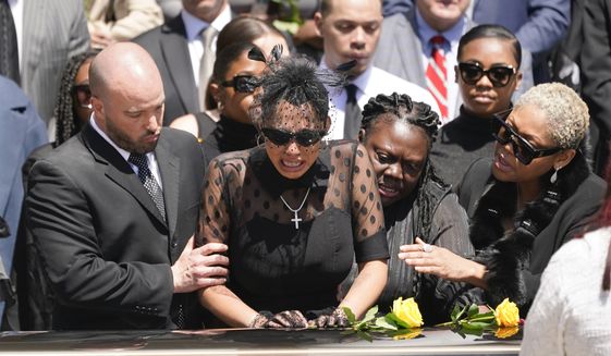 Friends and family console Kalabrya Haskins, center left, the widow of Pittsburgh Steelers NFL football player Dwayne Haskins, after a memorial service, Friday, April 22, 2022, in Pittsburgh. (AP Photo/Keith Srakocic)