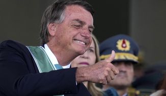 Brazil&#39;s President Jair Bolsonaro gives a thumbs up upon arrival for a ceremony marking Army Day at Army headquarters in Brasilia, Brazil, Tuesday, April 19, 2022. (AP Photo/Eraldo Peres)