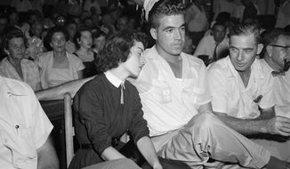 In this Sept. 22. 1955 photo, Carolyn Bryant rests her head on her husband Roy Bryant&#39;s shoulder after she testified in Emmett Till murder court case in Sumner, Miss. Stymied in their calls for a renewed investigation into the murder of Emmett Till, relatives and activists are advocating another possible path toward accountability in Mississippi: They want authorities to launch a kidnapping prosecution against the woman who set off the lynching by accusing the Chicago teen of improper advances in 1955. (AP Photo, File)