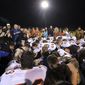 Bremerton assistant football coach Joe Kennedy, obscured at center in blue, is surrounded by Centralia High School football players as they kneel and pray with him on the field after their game against Bremerton on Oct. 16, 2015, in Bremerton, Wash. (Meegan M. Reid/Kitsap Sun via AP, File)