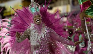 A performer from the Mangueira samba school parades during Carnival celebrations at the Sambadrome in Rio de Janeiro, Brazil, Friday, April 22, 2022. (AP Photo/Silvia Izquierdo)