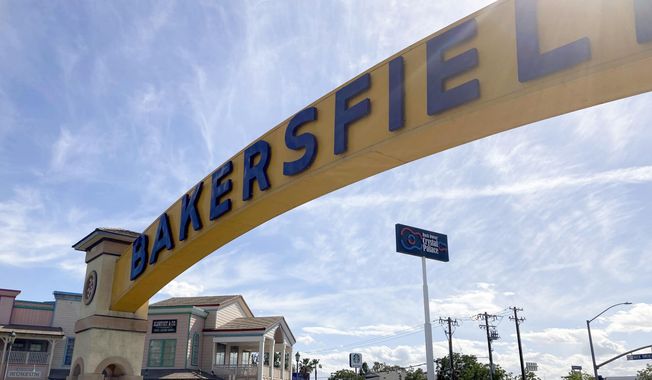A sign for Bakersfield, Calif., is displayed over Sillect Avenue at Buck Owens Drive on April 20, 2022. (AP Photo/Lisa Mascaro)