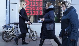 People walk past a currency exchange office screen displaying the exchange rates of U.S. Dollar and Euro to Russian Rubles in Moscow&#39;s downtown, Russia, Feb. 28, 2022. (AP Photo/File)
