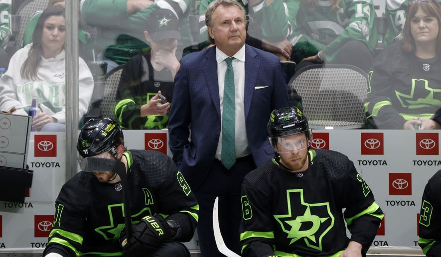 Dallas Stars head coach Rick Bowness, top center, center Tyler Seguin (91) and center Joe Pavelski (16) watch from the bench as they play the San Jose Sharks during the third period of an NHL hockey game in Dallas, Saturday, April 16, 2022. (AP Photo/Michael Ainsworth)