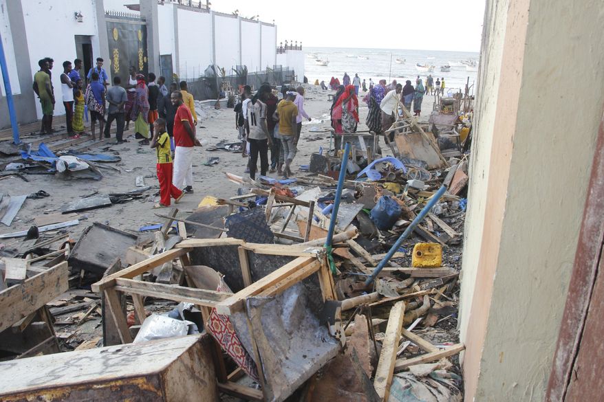 People look at destroyed shops in Mogadishu&#39;s Lido beach, Somalia, Saturday, April, 23, 2022, after a bomb blast by Somalia’s Islamic extremist rebels hit a popular seaside restaurant killing at least six people. Ambulance service officials say the explosion occurred Friday evening when many patrons gathered for an Iftar meal to break the Ramadan fast. (AP Photo/Farah Abdi Warsameh) ** FILE **