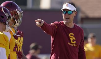 Southern California head coach Lincoln Riley talks with his quarterbacks during an NCAA college football practice Thursday, March 24, 2022, in Los Angeles. (AP Photo/Mark J. Terrill)
