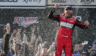 NASCAR Cup Series driver Ross Chastain (1) celebrates the win in Victory Lane following a NASCAR Cup Series auto race, Sunday, April 24, 2022, in Talladega, Ala. (AP Photo/Butch Dill)