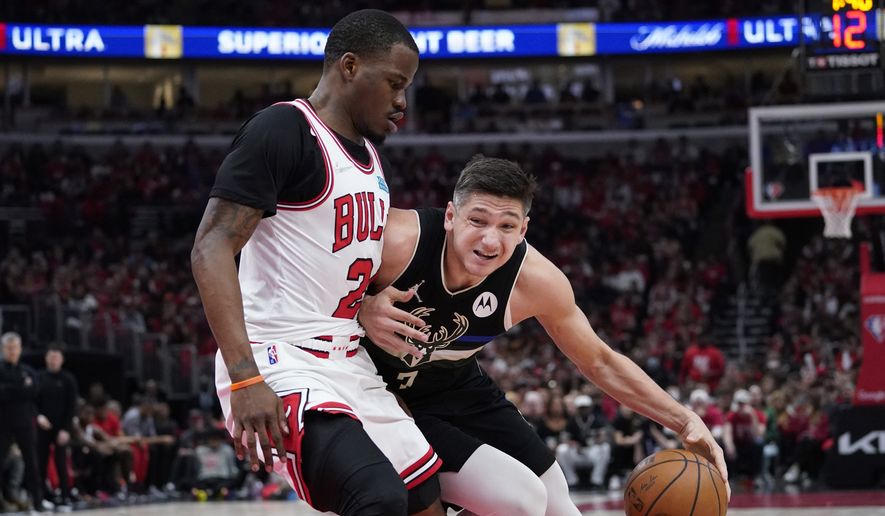 Milwaukee Bucks guard Grayson Allen, right, drives as Chicago Bulls forward Javonte Green guards during the second half of Game 4 of a first-round NBA basketball playoff series Sunday, April 24, 2022, in Chicago. (AP Photo/Nam Y. Huh)