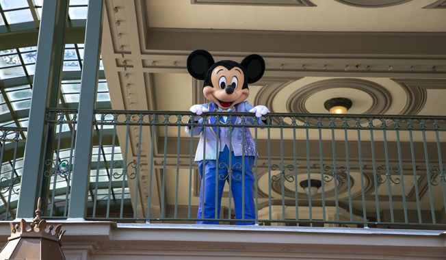 An actor dressed as Mickey Mouse greets visitors at the entrance to Magic Kingdom Park at Walt Disney World Resort in Lake Buena Vista, Florida, on Friday, April 22, 2022. Conservatives have claimed a series of victories of late against major corporations like Disney as they escalate their assault on &quot;woke&quot; corporate culture with letter campaigns, boycotts and shareholder activism. (AP Photo/Ted Shaffrey)  **FILE**