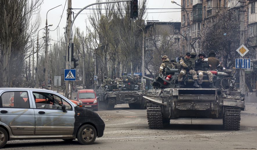 Russian tanks roll along a street in an area controlled by Russian-backed separatist forces in Mariupol, Ukraine, Saturday, April 23, 2022. (AP Photo/Alexei Alexandrov)
