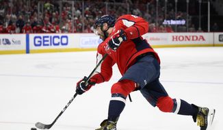 Washington Capitals left wing Alex Ovechkin (8) shoots during the first period of an NHL hockey game against the Toronto Maple Leafs, Sunday, April 24, 2022, in Washington. (AP Photo/Nick Wass)
