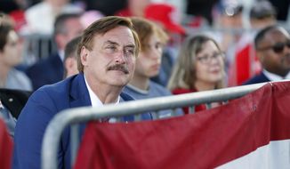 My Pillow CEO Mike Lindell listens to former President Donald Trump at the Save America Rally at the Delaware County Fairgrounds, Saturday, April 23, 2022, in Delaware, Ohio. Former President Donald Trump was on hand to endorse Republican candidates and turnout ahead of the May 3 Ohio primary. (AP Photo/Joe Maiorana)