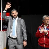 Washington Capitals left wing Alex Ovechkin, left, waves next to team owner Ted Leonsis, right, during a pre-game ceremony to honor Ovechkin for being in 3rd place in all-time goals before an NHL hockey game against the New York Islanders, Tuesday, April 26, 2022, in Washington. (AP Photo/Nick Wass)