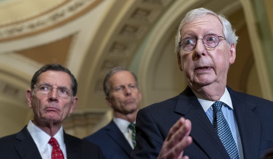 Senate Minority Leader Mitch McConnell of Ky., right, answers a question from a reporter, Tuesday, April 26, 2022, during a news conference on Capitol Hill in Washington. With McConnell are Sen. John Barrasso, R-Wyo., and Sen. John Thune, R-S.D., center. (AP Photo/Jacquelyn Martin) ** FILE **