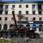 A destroyed tank and a damaged apartment building from heavy fighting are seen in an area controlled by Russian-backed separatist forces in Mariupol, Ukraine, Tuesday, April 26, 2022. (AP Photo/Alexei Alexandrov)